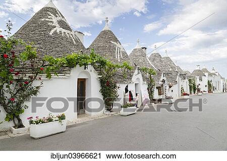 Stock Image - "Shop, trulli, traditional round houses, trullo settlement, Rione Monti district of Alberobello, Valle d'Itria, Trulli Valley, Apulia, Italy, Europe". Fotosearch
