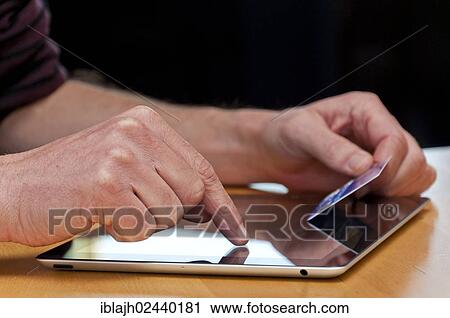 Shopping online with a tablet computer View Large Photo Image Stock Image - Shopping online with a tablet computer. Fotosearch