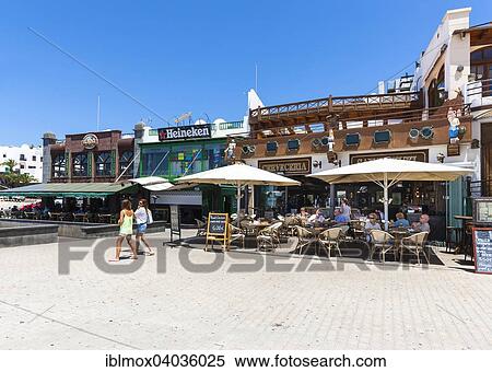 Stock Photography - "Shops and restaurants along the beach promenade, Puerto del Carmen, Lanzarote, Canary Islands, Spain, Europe". Fotosearch
