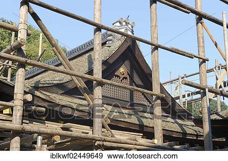 "Shrine building is surrounded by scaffolding consisting of long logs, renovation works of the roof with cypress bark, Kamogamo Shrine, Kyoto, Japan, East Asia, Asia" View Large Photo Image Stock Photo - "Shrine building is surrounded by scaffolding consisting of long logs, renovation works of the roof with cypress bark, Kamogamo Shrine, Kyoto, Japan, East Asia, Asia". Fotosearch
