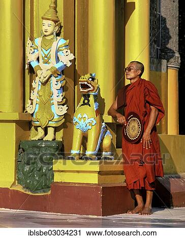 "Shwedagon Pagoda, monk standing next to a guardian figure, Rangun, Yangon Region, Myanmar, Burma, Asia" View Large Photo Image Stock Image - "Shwedagon Pagoda, monk standing next to a guardian figure, Rangun, Yangon Region, Myanmar, Burma, Asia". Fotosearch