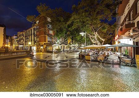 Stock Image - "Sidewalk cafes on Av Arriaga street in the historic district, Santa Luzia, Funchal, Madeira, Portugal, Europe". Fotosearch