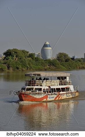 Picture - "Sightseeing boat on the Nile, behind the futuristic Corinthia Hotel, Kharthoum, Sudan, Africa". Fotosearch