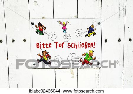 Picture - "Sign """"Bitte Tor schliessen"""", German for """"Please close the gate"""" on the gate to a kindergarten, Munich, Bavaria, Germany, Europe". Fotosearch