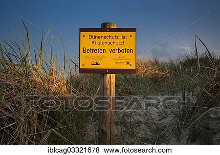 Stock Photo - "Sign, """"Duenenschutz ist Kuestenschutz"""", German for """"Dune protection is coastal protection"""", Ording-Nord beach, St. Peter-Ording, Eiderstedt, North Frisia, Schleswig-Holstein, Germany, Europe". Fotosearch