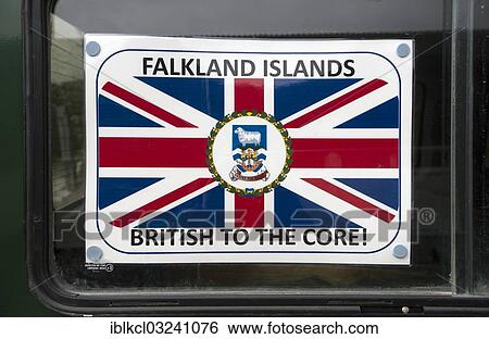 Stock Photograph - "Sign """"Falkland Islands - British to the Core"""" with a coat of arms and the flag of the Falkland Islands, displayed in a car window as a protest against Argentina's claim on the islands, Stanley, Ostfalkland, Falkland Islands, South America". Fotosearch