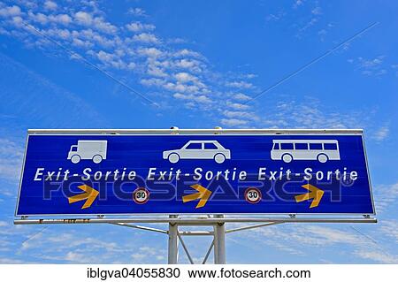 Stock Image - "Sign for the exit for motor vehicles in the port area, Calais, France, Europe". Fotosearch