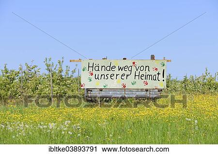 Stock Image - "Sign """"Hande weg von unserer Heimat"""", German for """"Hands off our home"""", Holzweilerhof farm near Grossbottwar, Baden-Wurttemberg, Germany, Europe". Fotosearch