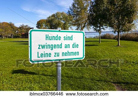 Stock Photograph - "Sign, """"Hunde sind zwingend an die Leine zu nehmen"""", German for """"dogs must be kept on a leash"""", Island Frauenchiemsee or Fraueninsel, Chiemsee, Upper Bavaria, Bavaria, Germany, Europe". Fotosearch
