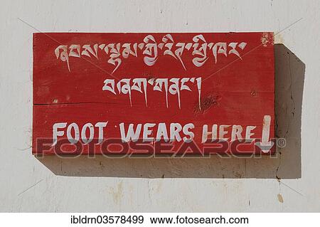 "Sign in Gangtey Monastery with the message """"Foot wears here"""", asking visitors to remove their footwear and leave it at this location, Wangdue Phodrang District, Bhutan, Asia" View Large Photo Image Stock Photo - "Sign in Gangtey Monastery with the message """"Foot wears here"""", asking visitors to remove their footwear and leave it at this location, Wangdue Phodrang District, Bhutan, Asia". Fotosearch
