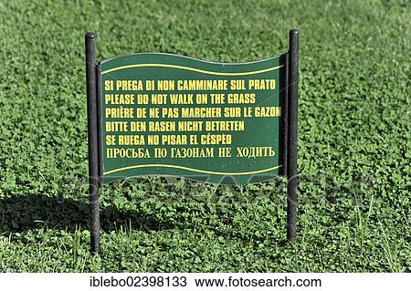 Stock Image - "Sign in six languages, """"please do not walk on the grass"""", courtyard of the Vatican Museums, Vatican, Rome, Lazio, Italy, Europe". Fotosearch