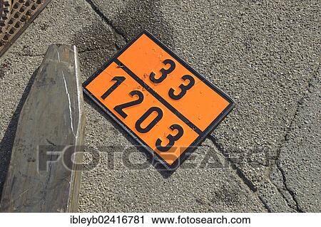 Stock Image - Sign indicating dangerous goods next to a forklift on the ground, the numbers 33 1203 mean petrol, the number 33 means highly flammable liquid, flash point below 23 degrees C, Germany, Europe. Fotosearch