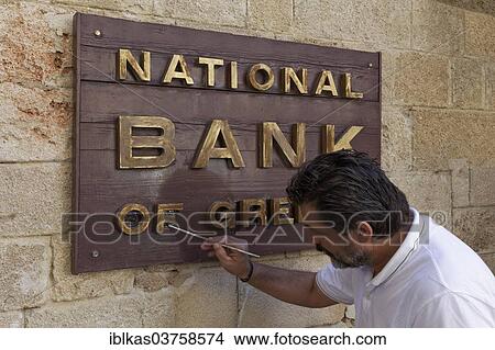"Sign """"National Bank of Greece"""", man painting the sign, new town, Rhodes, Rhodos Island, Dodecanese, Greece, Europe" View Large Photo Image Picture - "Sign """"National Bank of Greece"""", man painting the sign, new town, Rhodes, Rhodos Island, Dodecanese, Greece, Europe". Fotosearch