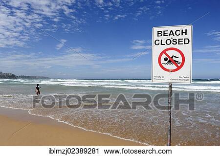 Stock Image - "Sign, No swimming, beach closed, Manly Beach, North Sydney, New South Wales, NSW, Pacific Ocean, Australia, Oceania". Fotosearch