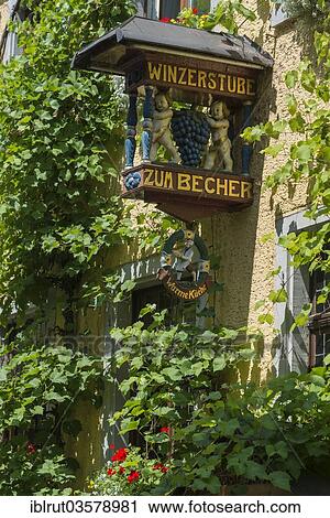 Stock Image - "Sign of a wine tavern on an ivy-covered house, Meersburg, Baden-Wurttemberg, Germany, Europe". Fotosearch