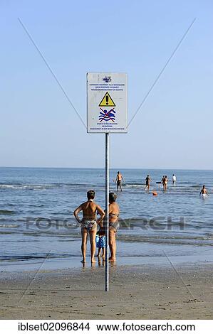"Sign """"swimming prohibited"""" and bathers on the beach of the northern Adriatic Sea, Cavallino, Jesolo, Venice, Europe" View Large Photo Image Picture - "Sign """"swimming prohibited"""" and bathers on the beach of the northern Adriatic Sea, Cavallino, Jesolo, Venice, Europe". Fotosearch