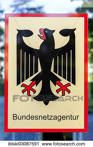 Stock Image - "Sign with federal eagle on the headquarters of the Bundesnetzagentur or Federal Network Agency, Bonn, Rhineland, North Rhine-Westphalia, Germany, Europe". Fotosearch