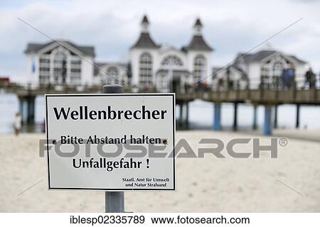 "Sign with inscription """"Wellenbrecher"""", German for """"breakwaters"""", pier at back, Baltic Sea resort of Sellin, Baltic Seaside Resort Sellin, Rugen, Mecklenburg-Western Pomerania, Germany, Europe" View Large Photo Image Stock Photo - "Sign with inscription """"Wellenbrecher"""", German for """"breakwaters"""", pier at back, Baltic Sea resort of Sellin, Baltic Seaside Resort Sellin, Rugen, Mecklenburg-Western Pomerania, Germany, Europe". Fotosearch