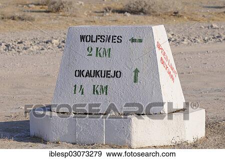 Stock Photo - "Signpost with directional arrows to Wolfsnes and Okaukuejo, Etosha-Pfanne, nahe Okondeka, Etosha-Nationalpark, Kunene Region, Namibia, Africa". Fotosearch