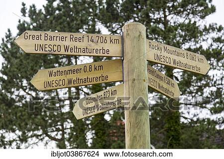 Picture - "Signposts pointing to various UNESCO World Heritage Sites, Spiekeroog, East Frisia, Lower Saxony, Germany, Europe". Fotosearch