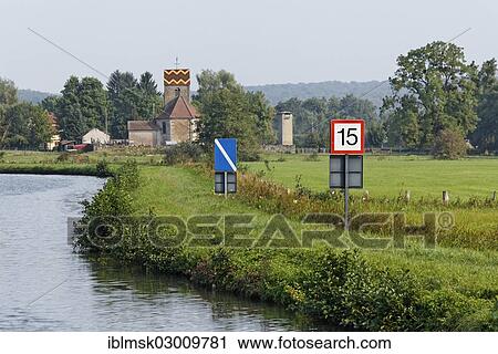 "Signs for boatmen on the Saone, with the village church with a Romanesque bell tower, Montureux-les-Baulay, Vesoul, Region Franche-Comte, Dep. Haute-Saone, France, Europe" View Large Photo Image Stock Image - "Signs for boatmen on the Saone, with the village church with a Romanesque bell tower, Montureux-les-Baulay, Vesoul, Region Franche-Comte, Dep. Haute-Saone, France, Europe". Fotosearch