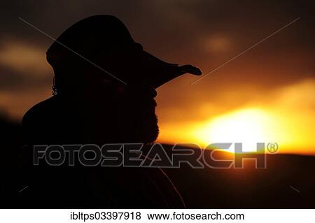 "Silhouette of a cowboy in profile looking towards the sunset, Cypress Hills, Saskatchewan Province, Canada, North America" View Large Photo Image Stock Photo - "Silhouette of a cowboy in profile looking towards the sunset, Cypress Hills, Saskatchewan Province, Canada, North America". Fotosearch