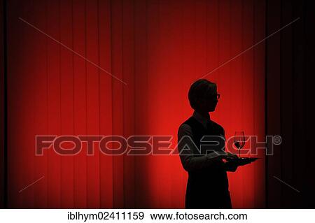 Stock Photo - Silhouette of a waitress against a red wall. Fotosearch