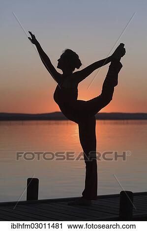 "Silhouette of a woman practicing yoga against the light of the evening sun, Steinhuder Meer, Steinhude, Lower Saxony, Germany, Europe" View Large Photo Image Stock Image - "Silhouette of a woman practicing yoga against the light of the evening sun, Steinhuder Meer, Steinhude, Lower Saxony, Germany, Europe". Fotosearch