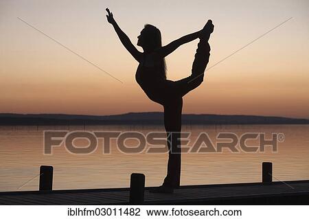 "Silhouette of a woman practicing yoga against the light of the evening sun, Steinhuder Meer, Steinhude, Lower Saxony, Germany, Europe" View Large Photo Image Stock Image - "Silhouette of a woman practicing yoga against the light of the evening sun, Steinhuder Meer, Steinhude, Lower Saxony, Germany, Europe". Fotosearch