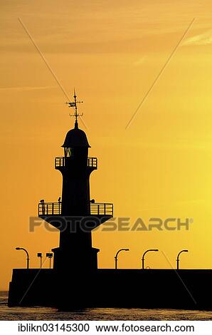 "Silhouette of the Brunsbuettel Mole 1 lighthouse in front of a evening sky, Brunsbuttel, Schleswig-Holstein, Germany, Europe" View Large Photo Image Stock Image - "Silhouette of the Brunsbuettel Mole 1 lighthouse in front of a evening sky, Brunsbuttel, Schleswig-Holstein, Germany, Europe". Fotosearch