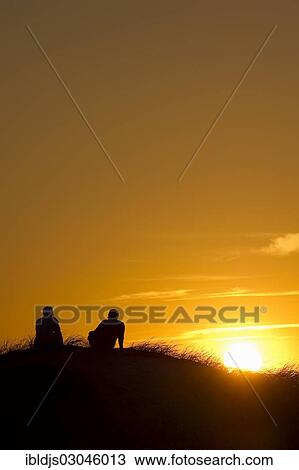 "Silhouette of two people in the dunes at sunset, Nebel, Amrum, Amrum, North Frisian Islands, Schleswig-Holstein, Germany, Europe" View Large Photo Image Stock Image - "Silhouette of two people in the dunes at sunset, Nebel, Amrum, Amrum, North Frisian Islands, Schleswig-Holstein, Germany, Europe". Fotosearch