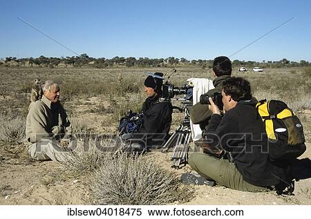 "Sir David Attenborough with meerkat on shoulder being filmed for BBC series Life of Mammals, producer Huw Cordey at front right, Kalahari Desert, Northern Cape, South Africa, Africa" View Large Photo Image Stock Photography - "Sir David Attenborough with meerkat on shoulder being filmed for BBC series Life of Mammals, producer Huw Cordey at front right, Kalahari Desert, Northern Cape, South Africa, Africa". Fotosearch
