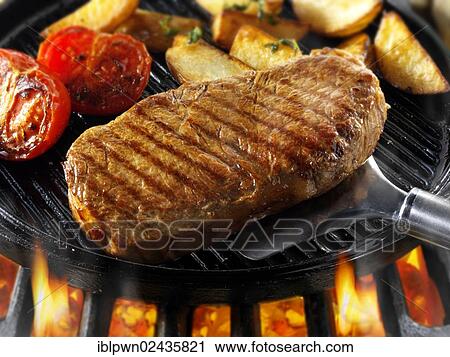 "Sirloin steak, steak, tomatoes and potato wedges on a grill" View Large Photo Image Stock Image - "Sirloin steak, steak, tomatoes and potato wedges on a grill". Fotosearch