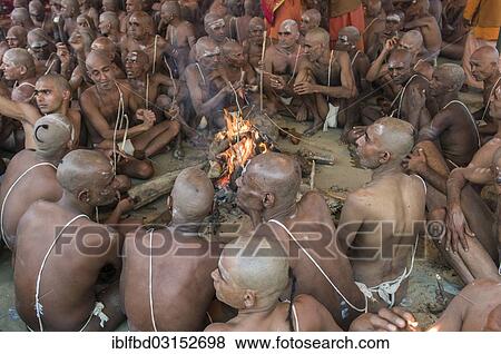 "Sitting around a bonfire and chanting mantras as part of the initiation of new sadhus, during Kumbha Mela festival, Allahabad, Uttar Pradesh, India, Asia" View Large Photo Image Stock Photo - "Sitting around a bonfire and chanting mantras as part of the initiation of new sadhus, during Kumbha Mela festival, Allahabad, Uttar Pradesh, India, Asia". Fotosearch