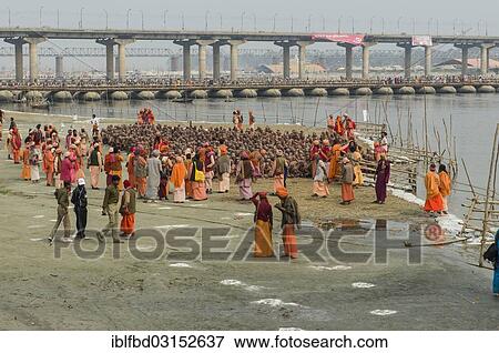 Stock Photo - "Sitting in silence as part of the initiation of new sadhus at the Sangam, the confluence of the rivers Ganges, Yamuna and Saraswati, during Kumbha Mela festival, Allahabad, Uttar Pradesh, India, Asia". Fotosearch