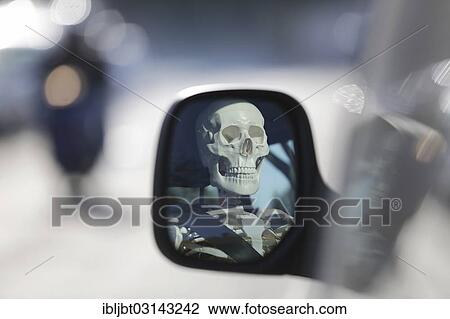 "Skeleton at the wheel of a car, skull reflected in the wing mirror of a car, Germany, Europe" View Large Photo Image Stock Image - "Skeleton at the wheel of a car, skull reflected in the wing mirror of a car, Germany, Europe". Fotosearch