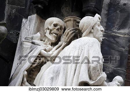 Stock Photo - "Skeleton, death, behind St. James, Memento Mori motif at the entrance of the Market Church of Sts. George and James, historic center, Hannover, Lower Saxony, Germany, Europe". Fotosearch