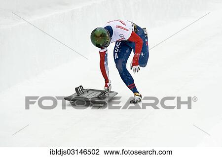 Stock Image - "Skeleton racer on the ice track, Skeleton World Cup 2013, St Moritz, Engadin, Grisons, Switzerland, Europe". Fotosearch
