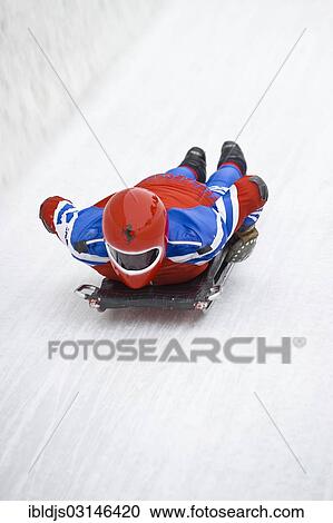 Stock Image - "Skeleton rider on the ice track, St Moritz, Engadin, Grisons, Switzerland, Europe". Fotosearch