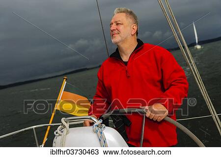 "Skipper standing at the helm of his yacht, Strelasund, Stralsund, Mecklenburg-Western Pomerania, Germany, Europe" View Large Photo Image Stock Image - "Skipper standing at the helm of his yacht, Strelasund, Stralsund, Mecklenburg-Western Pomerania, Germany, Europe". Fotosearch