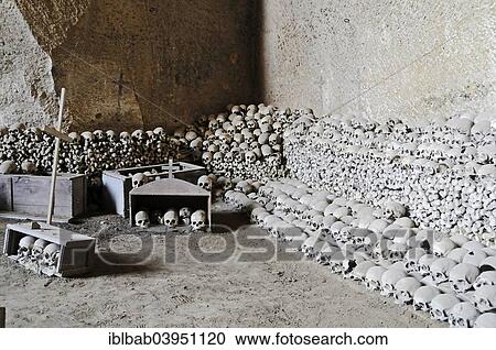 Stock Image - "Skulls, bones, Fontanelle cemetery, historic cemetery in an underground cave system, Naples, Campania, Italy, Europe". Fotosearch