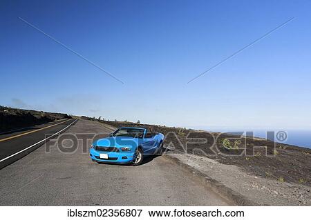Stock Photo - "Sky-blue Ford Mustang convertible by the sea, Big Island, Hawaii, USA". Fotosearch