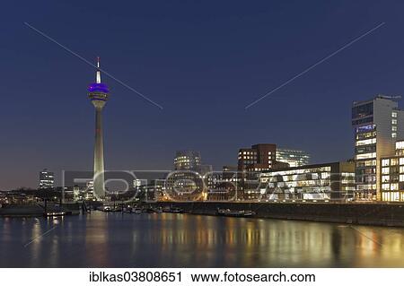 Stock Image - "Skyline, Media Harbour with Rhine Tower at the blue hour, Dusseldorf, North Rhine-Westphalia, Germany, Europe". Fotosearch