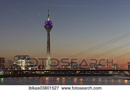 "Skyline with Rheinturm tower and """"Stadttor"""" high-rise building at twilight, Dusseldorf, North Rhine-Westphalia, Germany, Europe" View Large Photo Image Stock Photo - "Skyline with Rheinturm tower and """"Stadttor"""" high-rise building at twilight, Dusseldorf, North Rhine-Westphalia, Germany, Europe". Fotosearch
