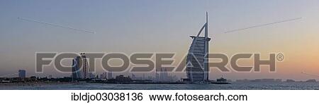 "Skyline with the Jumeirah Beach Hotel, left, and the Burj Al Arab Hotel off Jumeirah beach at dusk, Dubai, Emirate of Dubai, United Arab Emirates, Asia" View Large Photo Image Stock Photograph - "Skyline with the Jumeirah Beach Hotel, left, and the Burj Al Arab Hotel off Jumeirah beach at dusk, Dubai, Emirate of Dubai, United Arab Emirates, Asia". Fotosearch