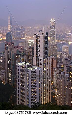 Stock Photograph - "Skyscrapers at dusk, Kowloon district at back, Victoria Harbour, Hong Kong, Hong Kong, China, People's Republic of China, Asia". Fotosearch