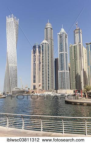 "Skyscrapers in the Dubai Marina district with promenade, marina, the Cayan Tower skyscraper, left, Dubai, United Arab Emirates, Asia" View Large Photo Image Stock Image - "Skyscrapers in the Dubai Marina district with promenade, marina, the Cayan Tower skyscraper, left, Dubai, United Arab Emirates, Asia". Fotosearch