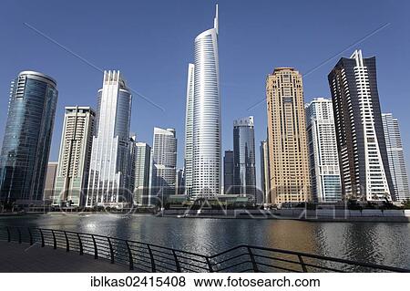 Stock Photo - Skyscrapers on an artificial lake, large scale construction project, Jumeirah Lake Towers, Dubai, United Arab Emirates, Middle East, Asia. Fotosearch