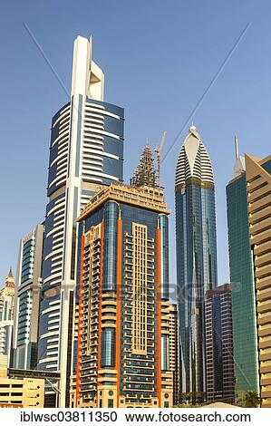 Stock Image - "Skyscrapers with glass facades, Rose Rayhaan Hotel at the back, Sheikh Zayed Road, Dubai, United Arab Emirates, Asia". Fotosearch