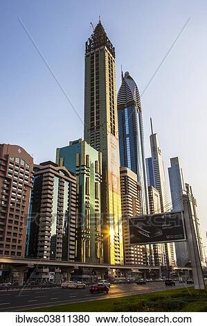 "Skyscrapers with glass facades, Rose Rayhaan Hotel at the back, Sheikh Zayed Road, Dubai, United Arab Emirates, Asia" View Large Photo Image Stock Image - "Skyscrapers with glass facades, Rose Rayhaan Hotel at the back, Sheikh Zayed Road, Dubai, United Arab Emirates, Asia". Fotosearch